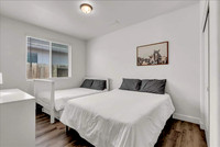 bedroom 1 with s full and queen bed.