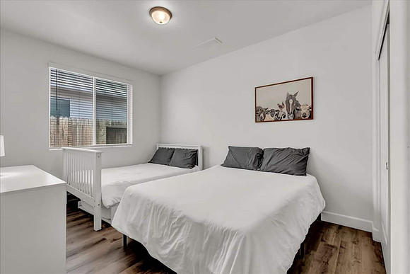 bedroom 1 with s full and queen bed.