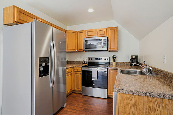 Equipped with an electric oven, microwave, and dishwasher.