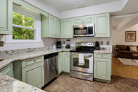 Full refrigerator, microwave, stove, and dishwasher.