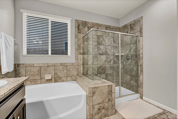Master bedroom with soaking tub and walk in shower.