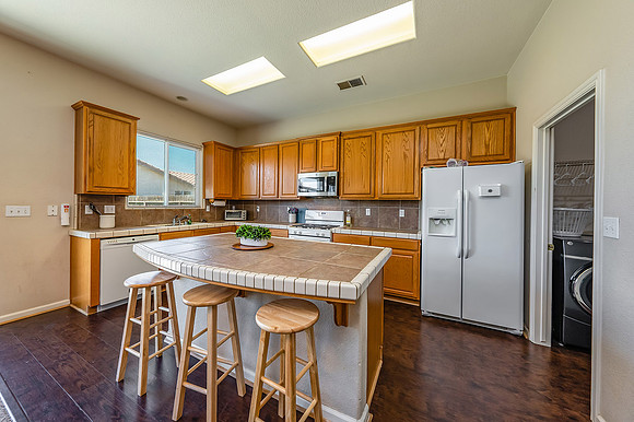 Kitchen to seating for 3 adults.